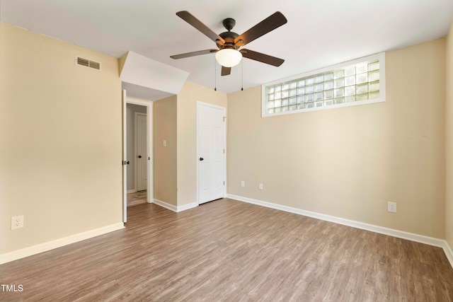 spare room with light hardwood / wood-style floors and ceiling fan