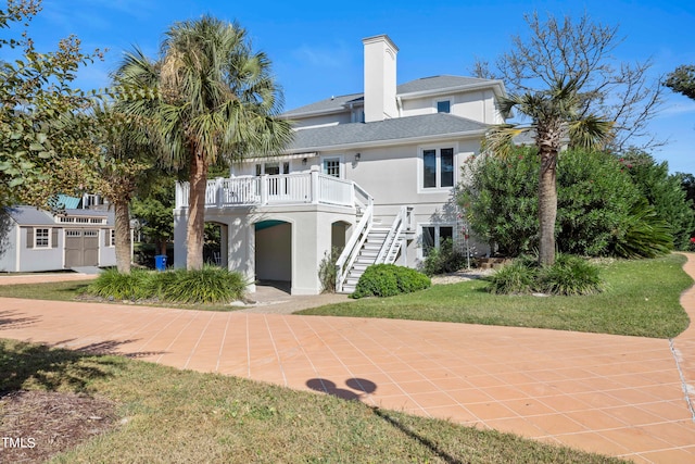 rear view of house featuring a lawn