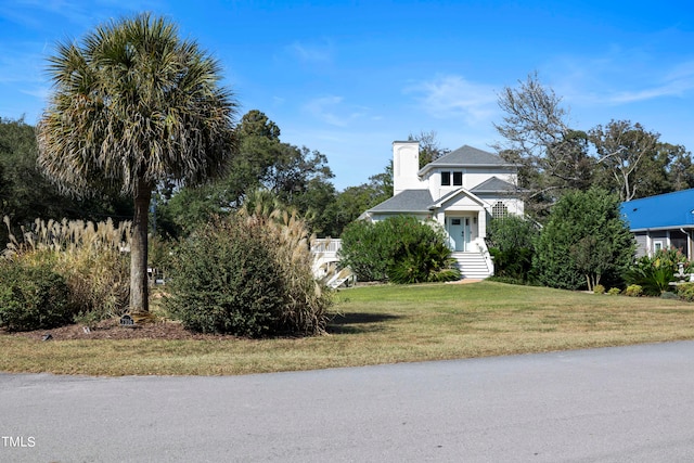 obstructed view of property with a front yard