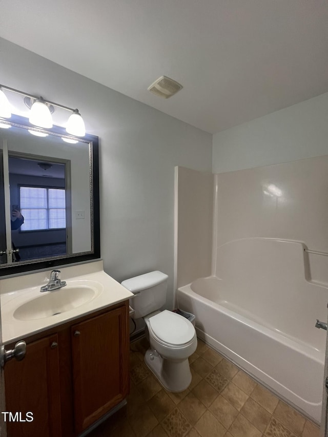 full bathroom featuring vanity, toilet, and  shower combination