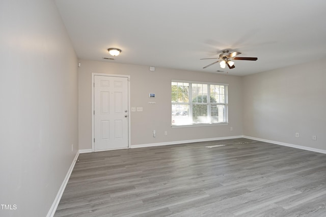 spare room featuring hardwood / wood-style flooring and ceiling fan