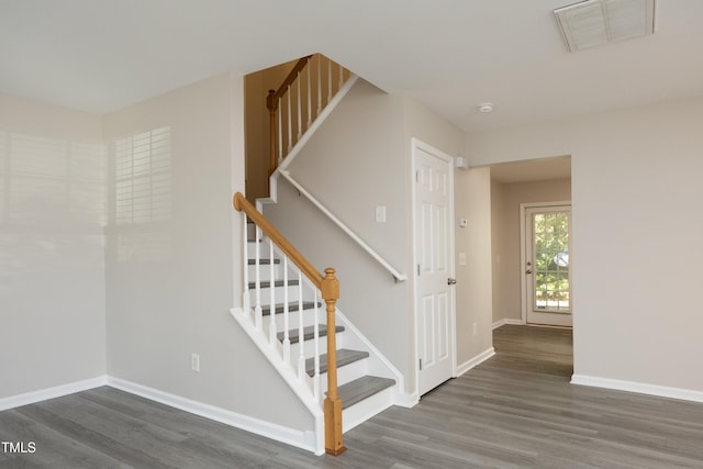 stairs featuring wood-type flooring