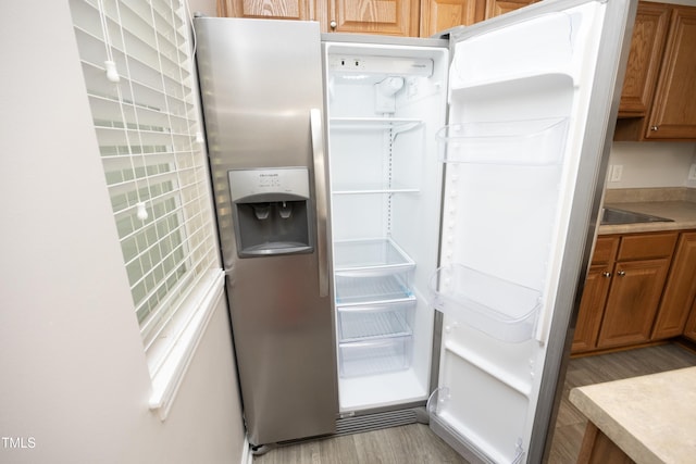 kitchen featuring stainless steel fridge and light wood-type flooring