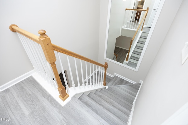 stairs featuring wood-type flooring