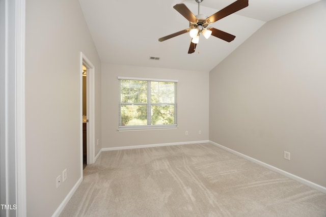 carpeted empty room with vaulted ceiling and ceiling fan