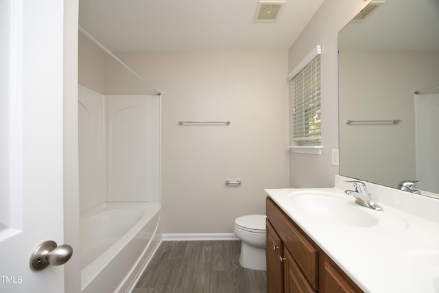 full bathroom with vanity, hardwood / wood-style floors, toilet, and shower / bath combination