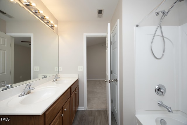 bathroom featuring shower / tub combination, vanity, and wood-type flooring