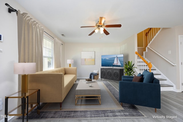 living room with hardwood / wood-style floors and ceiling fan