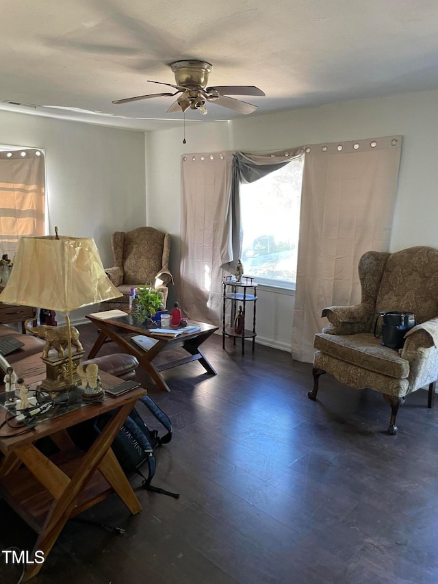 living area with dark hardwood / wood-style floors and ceiling fan