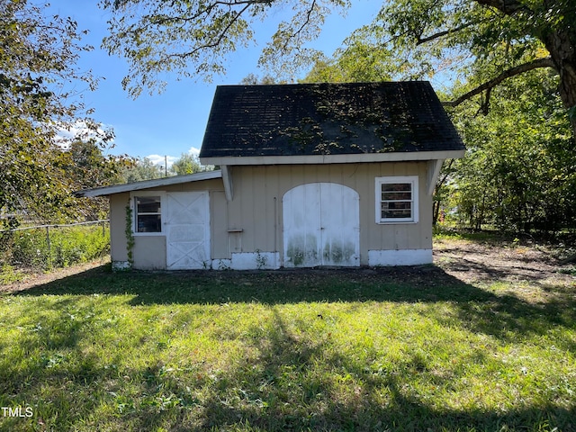 view of outdoor structure featuring a lawn