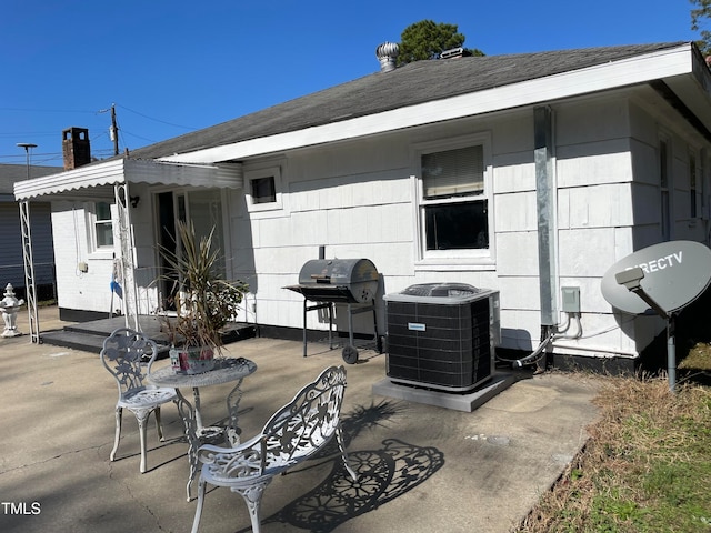 view of patio / terrace with cooling unit and a grill