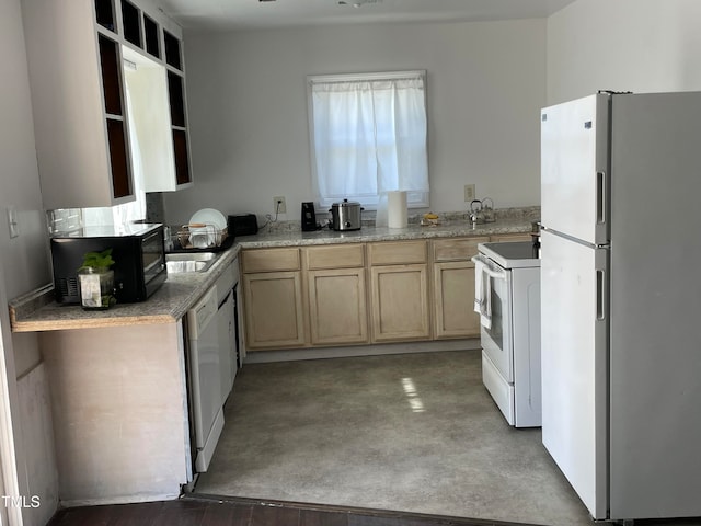 kitchen with light brown cabinets, concrete flooring, and white appliances