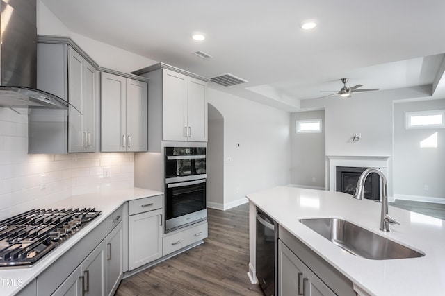 1230 Linkwood, Home, Fuquay Varina, NC 27526 - kitchen featuring wall chimney range hood, gray cabinets, appliances with stainless steel finishes, dark wood finished floors, and recessed lighting