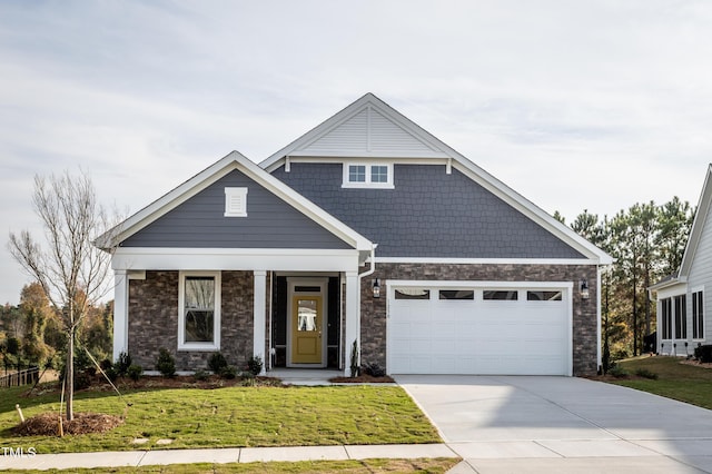 craftsman-style home featuring a garage and a front lawn