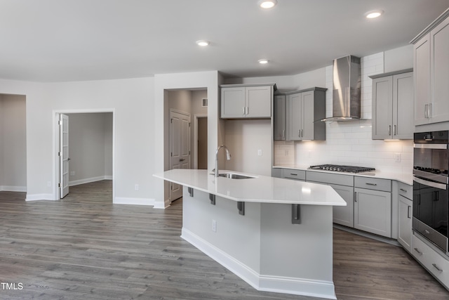 1230 Linkwood, Home, Fuquay Varina, NC 27526 - kitchen with wall chimney range hood, gray cabinets, appliances with stainless steel finishes, a center island with sink, and recessed lighting