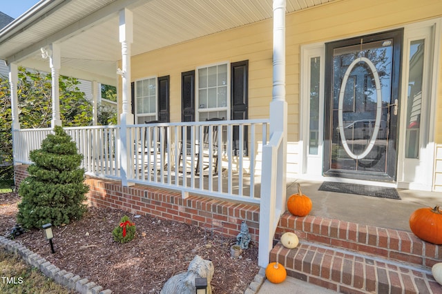 view of exterior entry featuring a porch