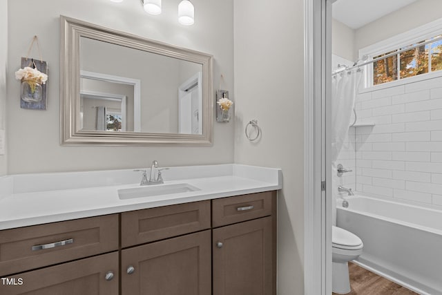 full bathroom featuring toilet, shower / tub combo with curtain, vanity, and hardwood / wood-style floors