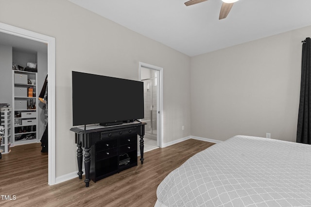 bedroom featuring wood-type flooring, ceiling fan, and ensuite bath