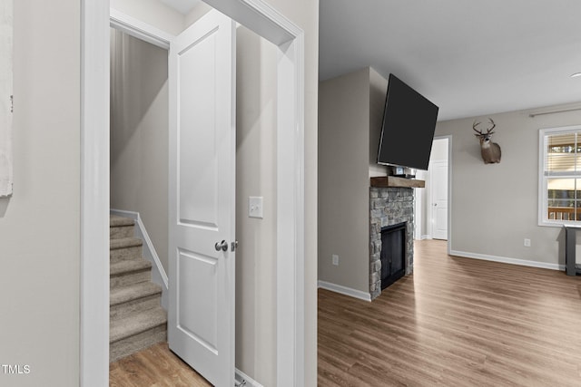 interior space with a fireplace and wood-type flooring