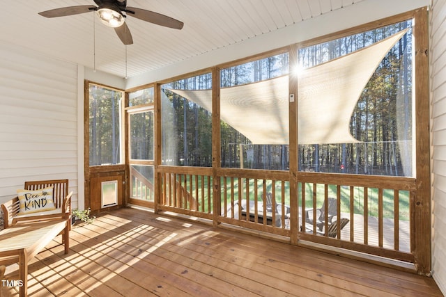 unfurnished sunroom featuring wooden ceiling and ceiling fan