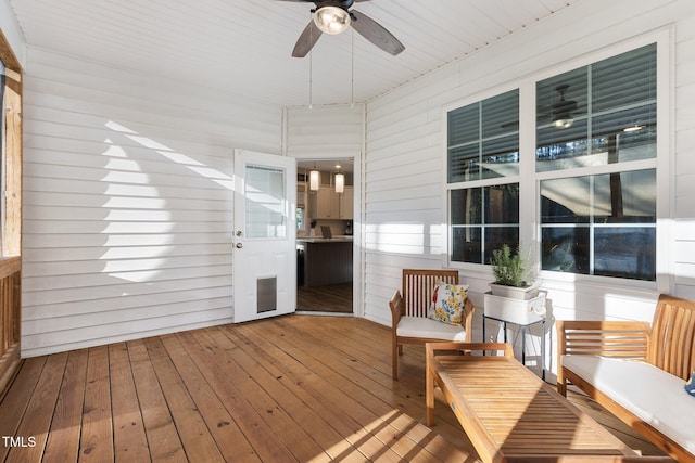 unfurnished sunroom with wooden ceiling and ceiling fan