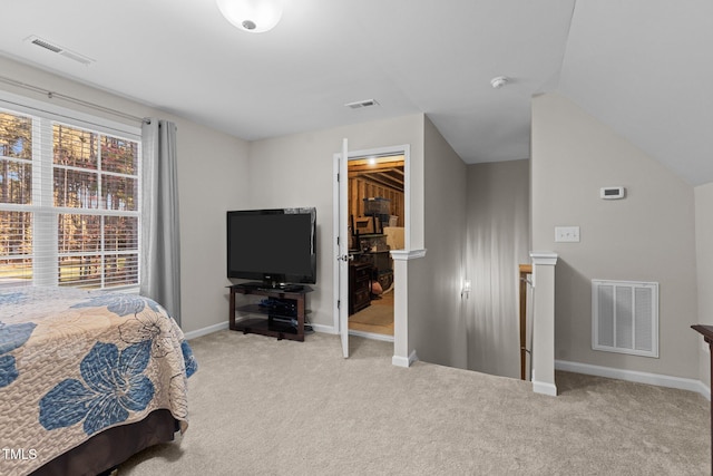 carpeted bedroom with lofted ceiling