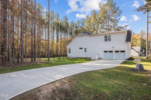 view of property exterior featuring a garage and a yard