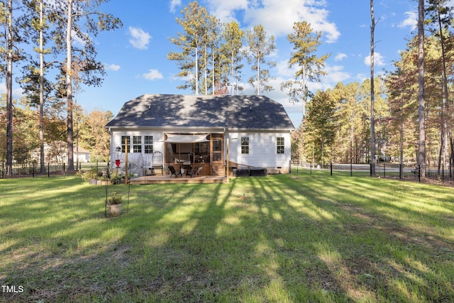 rear view of house with a lawn and a deck