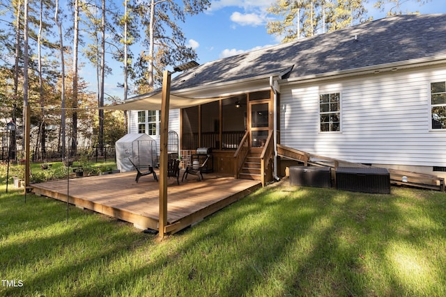 rear view of property featuring a deck and a yard