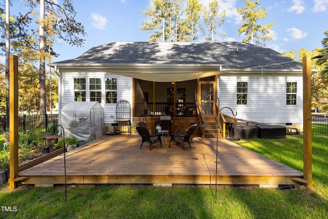 rear view of house featuring a lawn