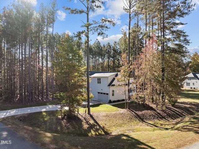 exterior space featuring a garage and a yard