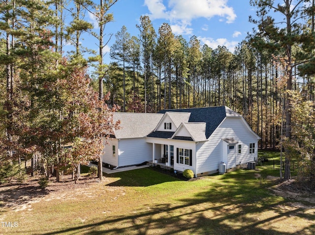 view of front of property featuring a front lawn and central air condition unit