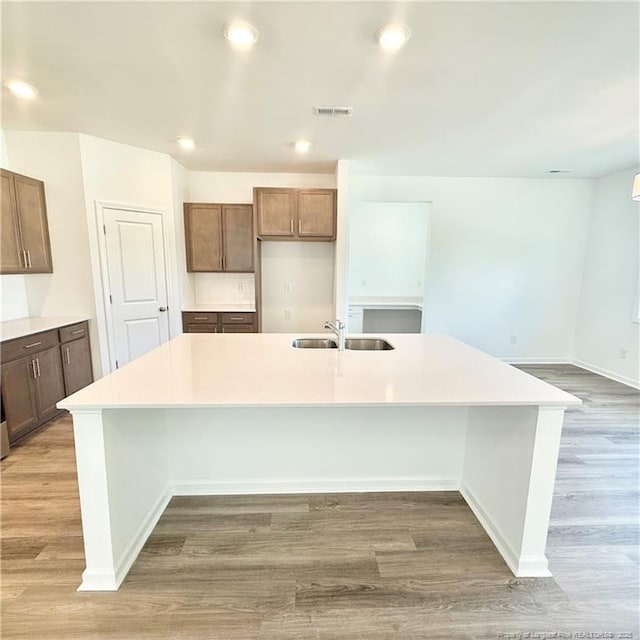145 Cahill, Home, Raeford, NC 28376 - kitchen with a sink, a spacious island, light wood-style floors, light countertops, and baseboards