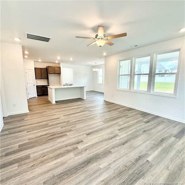 145 Cahill, Home, Raeford, NC 28376 - unfurnished living room with light wood finished floors, baseboards, ceiling fan, and recessed lighting