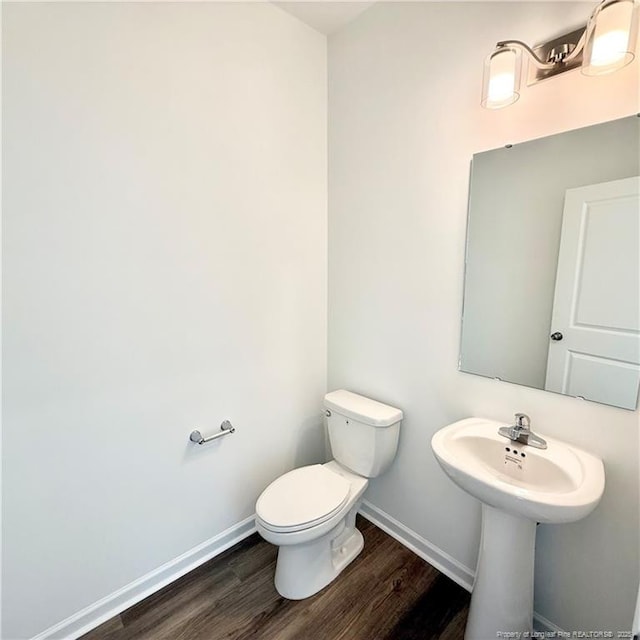 145 Cahill, Home, Raeford, NC 28376 - half bath featuring wood finished floors, baseboards, and toilet