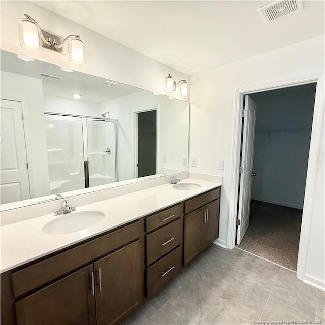 145 Cahill, Home, Raeford, NC 28376 - full bathroom with a shower stall, a spacious closet, double vanity, and baseboards
