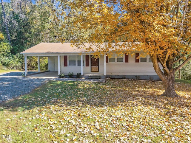 view of front of property with a porch, a front lawn, and a carport