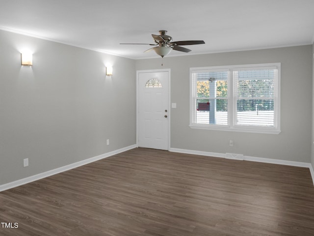 foyer entrance with crown molding, dark hardwood / wood-style floors, and ceiling fan