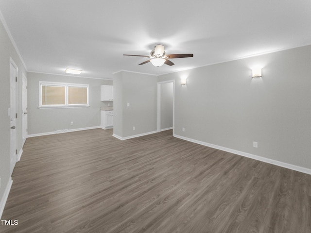 empty room with ceiling fan, crown molding, and dark hardwood / wood-style floors