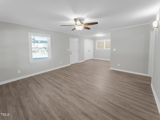 empty room featuring crown molding, ceiling fan, and dark hardwood / wood-style flooring