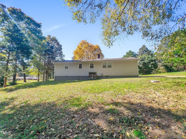 rear view of property featuring a yard