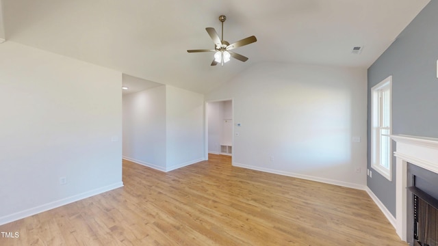 unfurnished living room featuring ceiling fan, baseboards, lofted ceiling, and light wood-type flooring