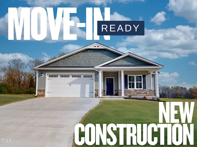211 Creeks Edge Dr, Pikeville, NC 27863 - view of front facade with concrete driveway, a front yard, a garage, and stone siding