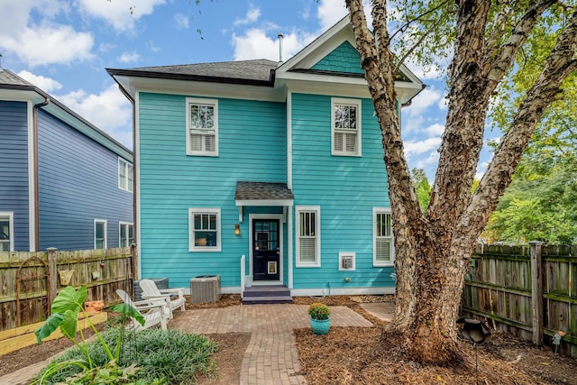 rear view of property featuring central AC and a patio