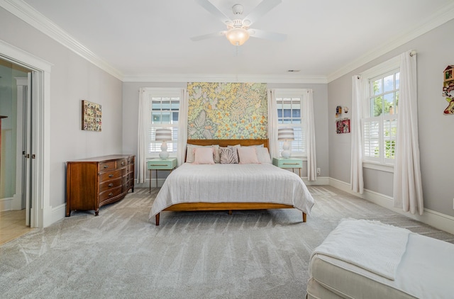 carpeted bedroom featuring ceiling fan and crown molding