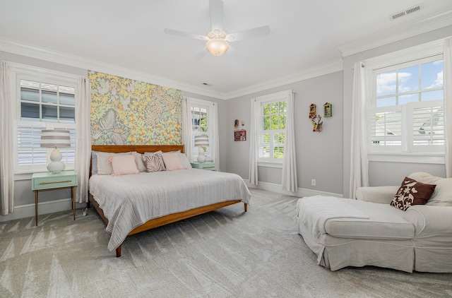 carpeted bedroom with ceiling fan and crown molding