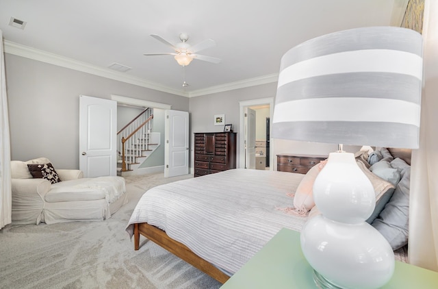 carpeted bedroom featuring ceiling fan and ornamental molding