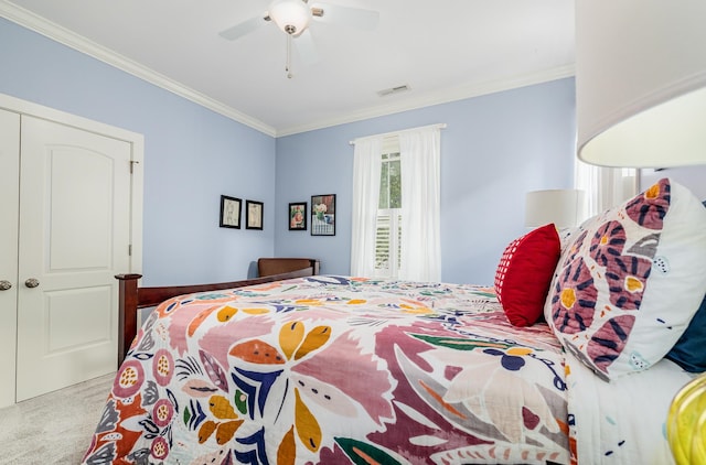 bedroom featuring a closet, light carpet, ornamental molding, and ceiling fan