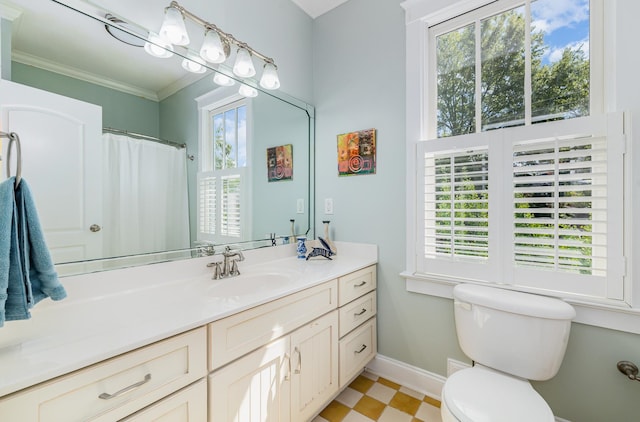 bathroom with vanity, crown molding, toilet, and a wealth of natural light