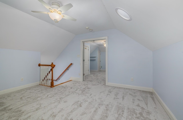 bonus room with light carpet, vaulted ceiling, and ceiling fan